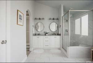 Bathroom featuring vanity and an enclosed shower