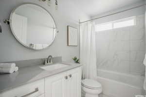 Full bathroom featuring shower / bath combo, toilet, and vanity