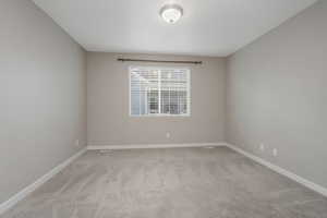 Unfurnished room featuring light colored carpet