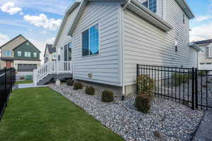 View of side of property featuring a yard