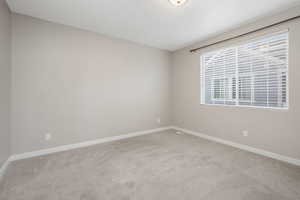 Empty room featuring light colored carpet