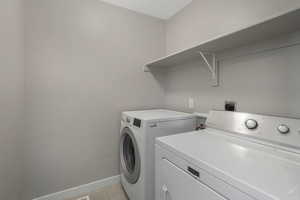 Clothes washing area featuring washer and clothes dryer