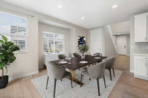 Dining room featuring light wood-type flooring and plenty of natural light