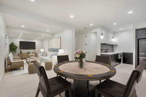 Carpeted dining space with sink