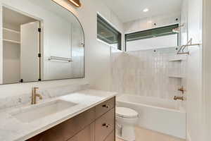 Full bathroom featuring tile patterned flooring, vanity, toilet, and tub / shower combination