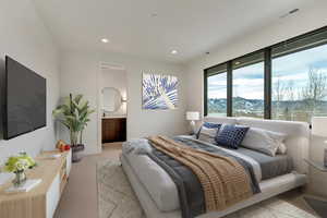 Carpeted bedroom with a mountain view and connected bathroom