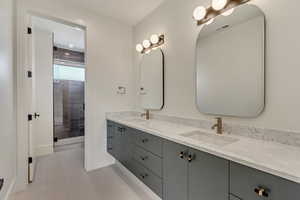 Bathroom featuring tile patterned flooring and vanity