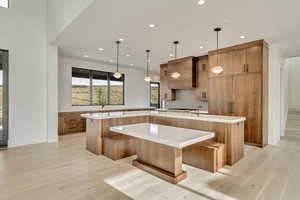 Kitchen featuring a spacious island, seated breakfast nook double ovens.