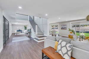 Living room featuring dark hardwood / wood-style floors and a wealth of natural light