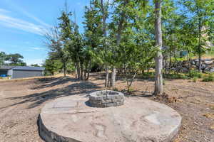 View of yard with an outdoor fire pit