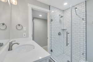 Bathroom with vanity and a shower with shower door