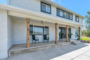 View of exterior entry with covered porch