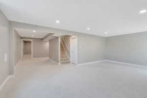 Basement featuring light colored carpet