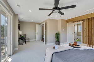 Carpeted bedroom featuring access to outside and ceiling fan