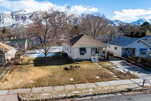 View of front of home featuring a mountain view and a front yard