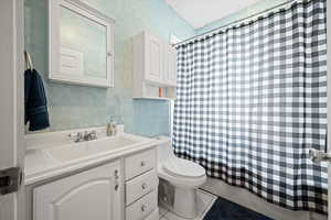 Bathroom featuring tile patterned flooring, vanity, and toilet