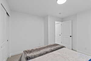 Bedroom featuring carpet floors and a closet