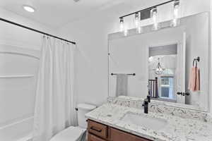 Full bathroom with vanity, toilet, and shower / tub combo