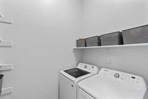 Laundry room with washing machine and clothes dryer