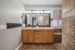 Bathroom with vanity and crown molding