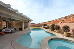 View of swimming pool with an in ground hot tub, a patio, and an outdoor hangout area