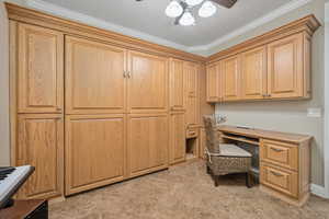 Home office with crown molding and ceiling fan