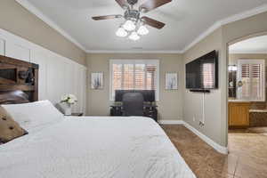 Bedroom featuring tile patterned flooring, ceiling fan, ornamental molding, and a textured ceiling