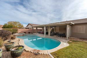 View of swimming pool featuring outdoor lounge area, a patio area, and an in ground hot tub