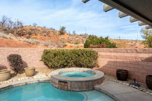 View of pool with an in ground hot tub