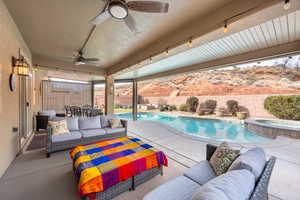 View of pool with outdoor lounge area, ceiling fan, an in ground hot tub, and a patio