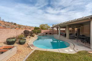 View of pool with a patio and ceiling fan