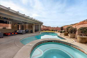 View of pool with an in ground hot tub, ceiling fan, a patio, and an outdoor living space