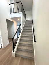 Staircase featuring wood-type flooring