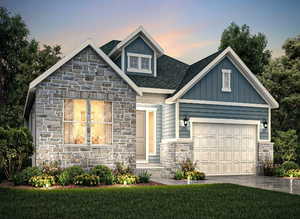 View of front of home with a yard and a garage