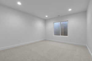 Unfurnished room with light carpet