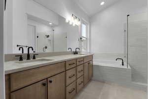 Bathroom featuring lofted ceiling, separate shower and tub, tile patterned flooring, and vanity