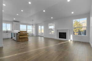 Living room with hardwood / wood-style floors and a notable chandelier