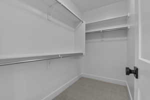 Spacious closet with light colored carpet