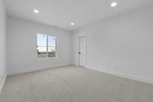 Unfurnished room featuring light colored carpet