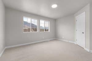 Spare room with light carpet and a mountain view