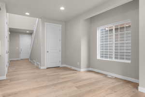 Unfurnished room with light wood-type flooring