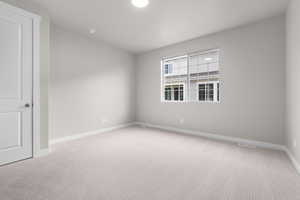 Spare room with light colored carpet