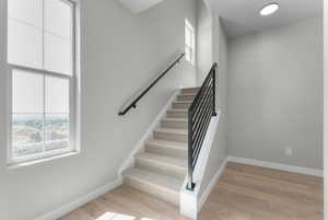 Stairway with hardwood / wood-style floors