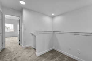 Spacious closet featuring carpet flooring