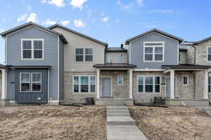 View of front of house featuring central AC