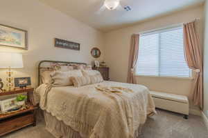 Carpeted bedroom with ceiling fan