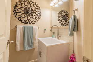 Bathroom with backsplash and vanity