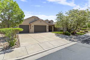 Mediterranean / spanish-style home with a garage, stucco siding, driveway, and a tiled roof
