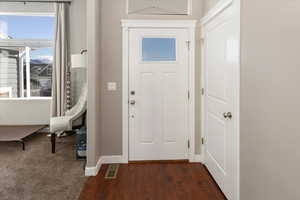 Entrance foyer featuring dark wood-type flooring