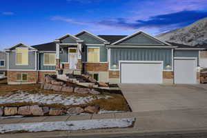 View of front of house with a mountain view and a garage